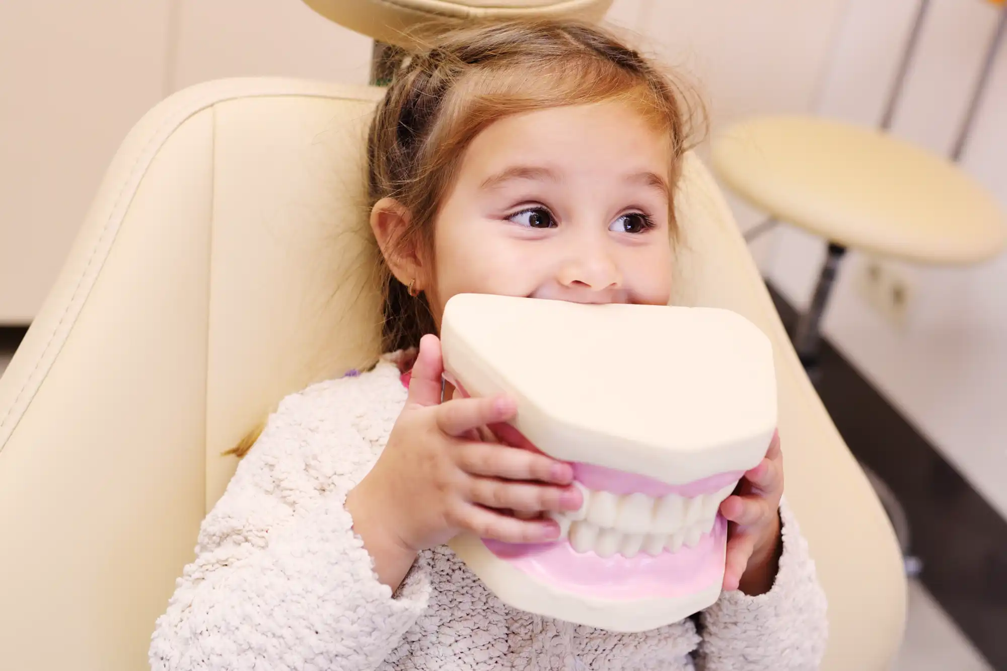 Pediatric Patient Holding Teeth Mould